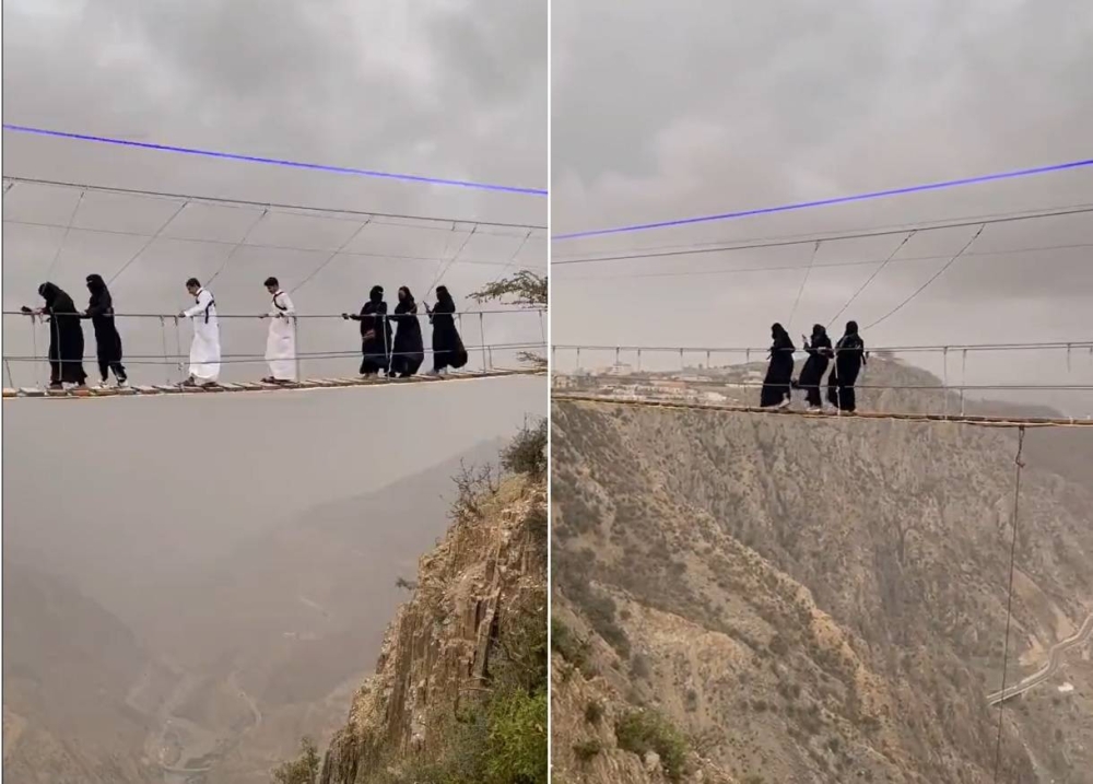 فتيات يعبرن ممشى فوق جسر معلق بين السحاب في الباحة.. شاهد: ردة فعلهن أثناء السير من علو شاهق