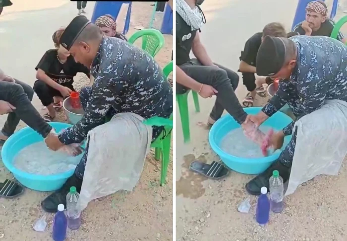 بالفيديو.. ضابط عراقي يغسل أقدام زائر إيراني بالماء والصابون في كربلاء